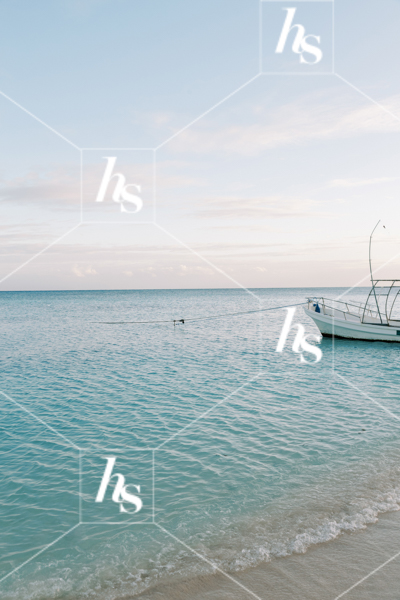 Stock image of a boat in the blue sea with blue skies, part of Digital Nomad seasonal travel & lifestyle stock photos and videos collection by Haute stock