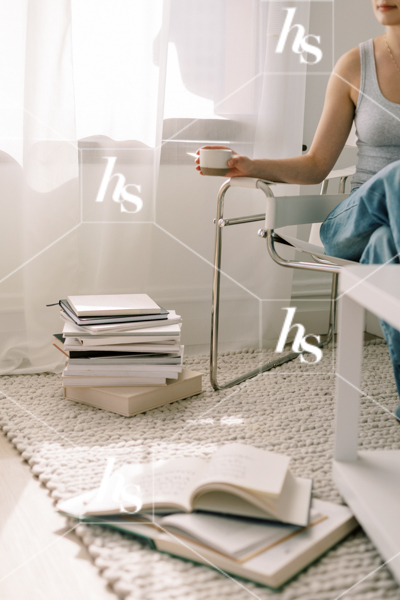 Woman taking a short break to enjoy her coffee after studying, part of Blank space collection of workspace & interior stock imagery