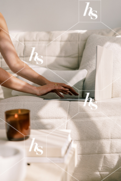 Woman typing on laptop while sitting on couch, part of Blank space collection of workspace & interior stock imagery