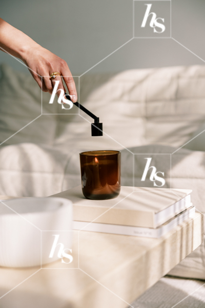 Photo of A woman snuffing out a candle, part of Blank space collection of workspace & interior stock imagery