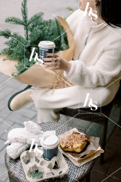 Stock image of woman enjoying a coffee at the local coffee shop, part of Snow Day collection of winter holiday stock images