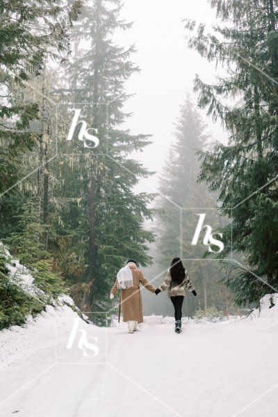 Best friends holding hands on a walk in the snow, part of Snow Day winter holiday stock images collection by Haute Stock