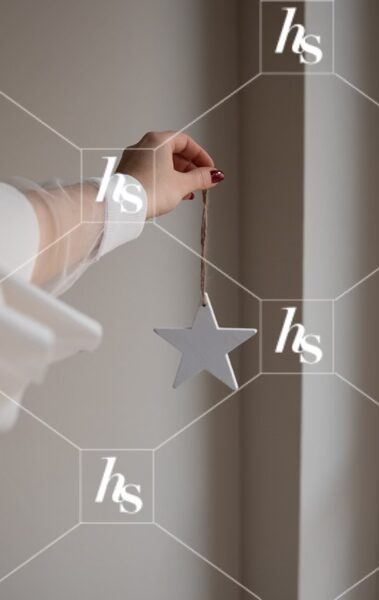 Woman holding star ornament, part of Gingerbread cozy holiday stock images collection by Haute Stock