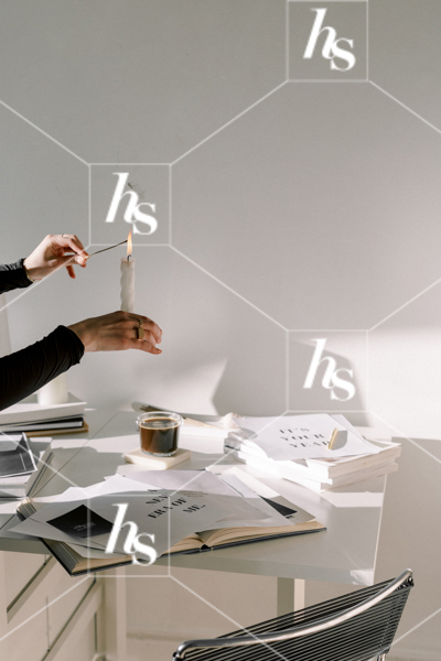 Woman lighting incense with a candle, part of Haute Stock's manifesting stock images collection