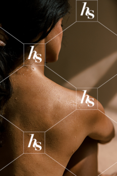 Woman in black bra and underwear sitting in chair covered by shadows, part of bare wellness collection of stock images