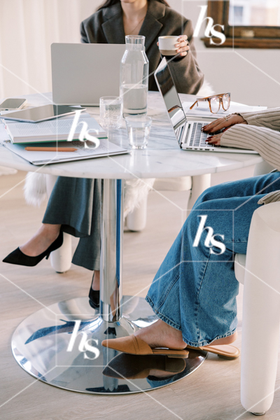 Co-workers seated and ready to start their team meeting, part of collaboration stock imagery collection by Haute Stock