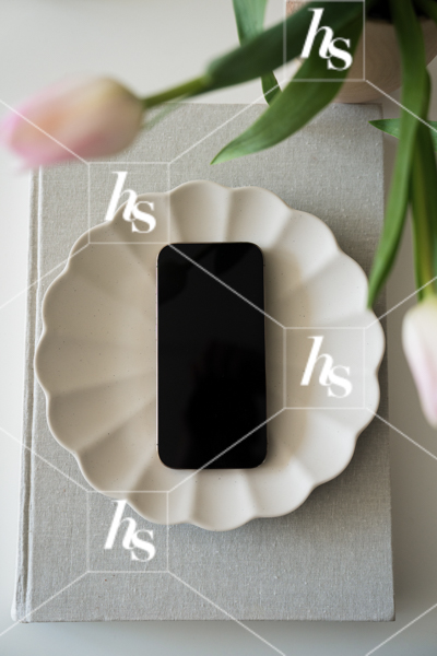 iPhone mockup in cute dish surrounded by pink tulips, part of Anthology collection of interior-inspired stock photos for creative studios, designers, and lifestyle brands.