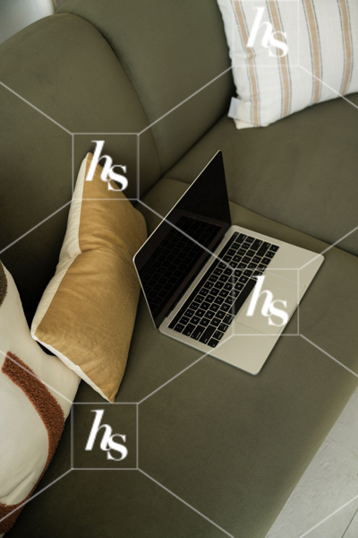 an image of a Laptop on green couch, part of a collection of interior-inspired stock photos for creative studios, designers, and lifestyle brands.