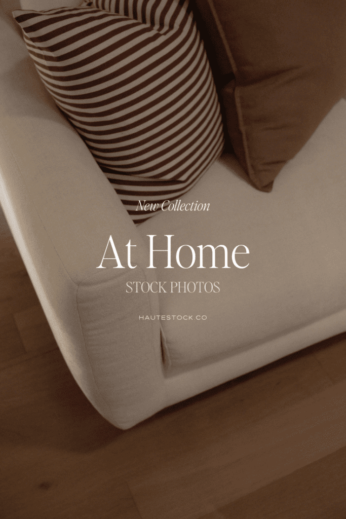 Neutral sofa styled with striped and solid pillows in warm tones, creating a cozy, lived in home atmosphere. At Home Haute Stock photo collection.